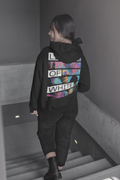 I Don't Wanna back-print hoodie by Lines Of White — back view, worn by a woman on the stairs