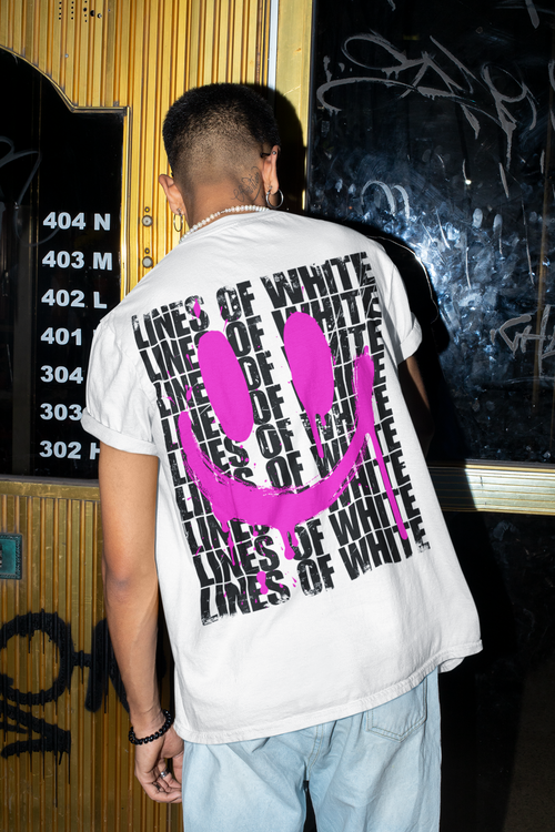 Acid Drip back-print tee by Lines Of White — back view, worn by a man opening a door