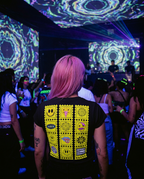 Smile Tripping t-shirt back print in a club with kaleidoscopic projection visuals
